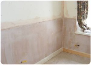 Wall with fresh plaster after rising damp solution has been applied